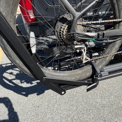 close-up of arm of Kuat Piston ION loaded with e-bike