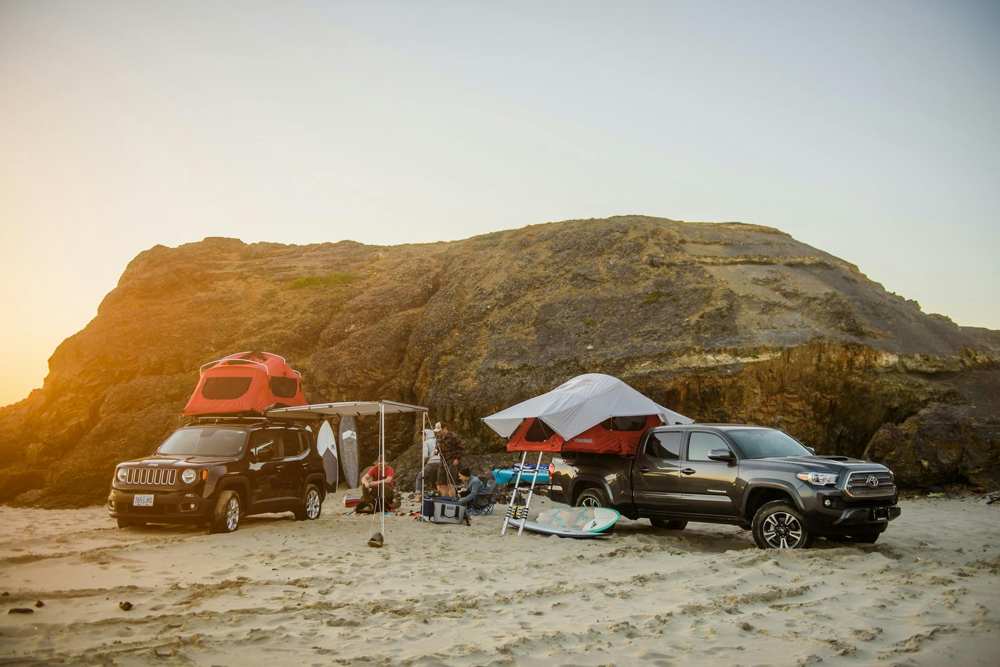 suv and truck with roof top tent on beach