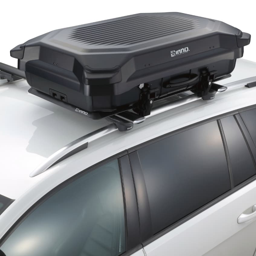 Inno BRL160MBK Gear Carry Cargo box installed on crossbars on white vehicle