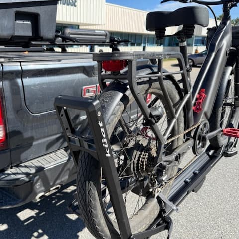 angled view close-up of arm and tray mechanism on Kuat Piston ION loaded with e-bike