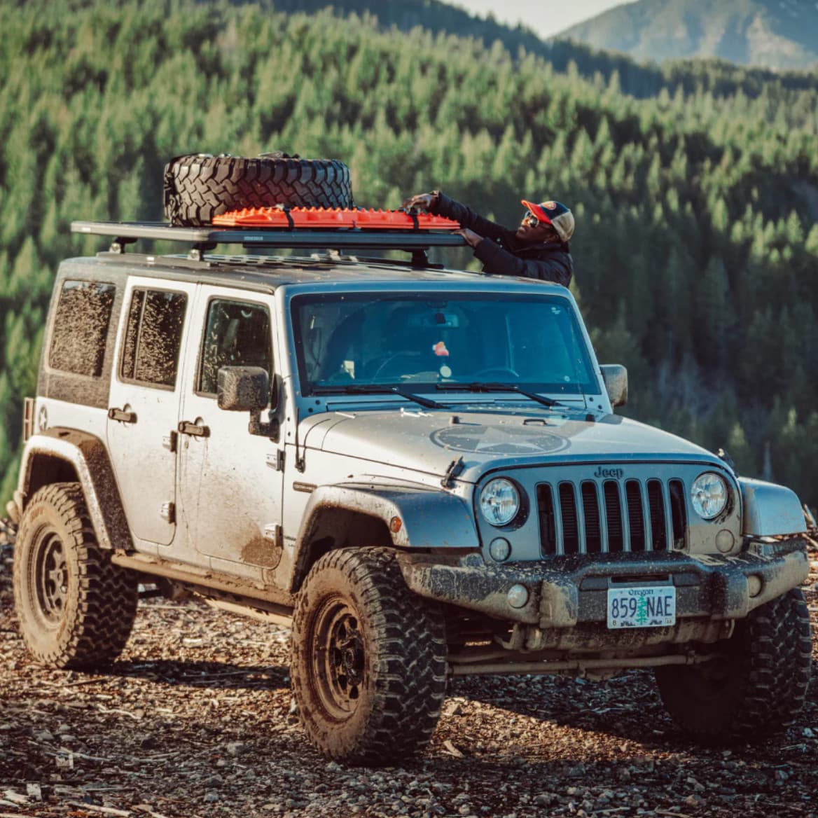 Lifestyle picture of Jeep JK outfitted with Yakima RibCage, LockNLoad platform, spare tire and recovery boards