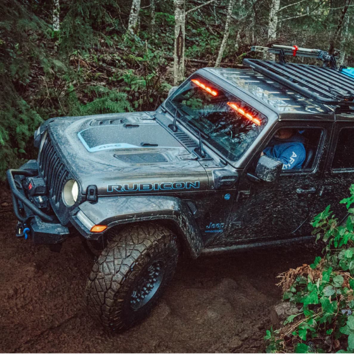 Lifestyle picture of Jeep Rubicon JL off-roading with the Yakima RibCage and LockNLoad platform B attached