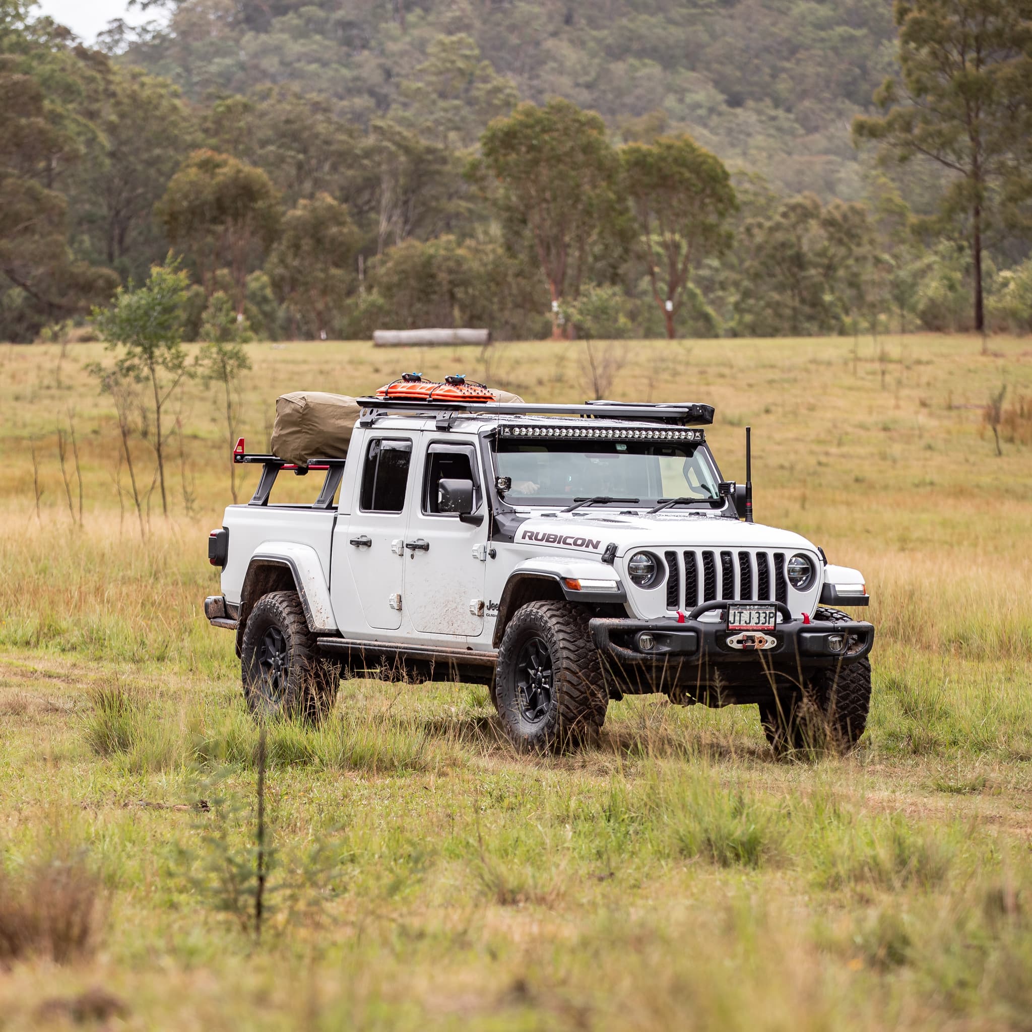 Maxtrax XTREME recovery board in signature orange installed on rack on top of SUV