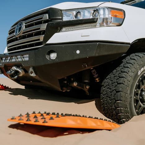 Maxtrax xtreme recovery boards being used in an extraction of SUV stuck in sand