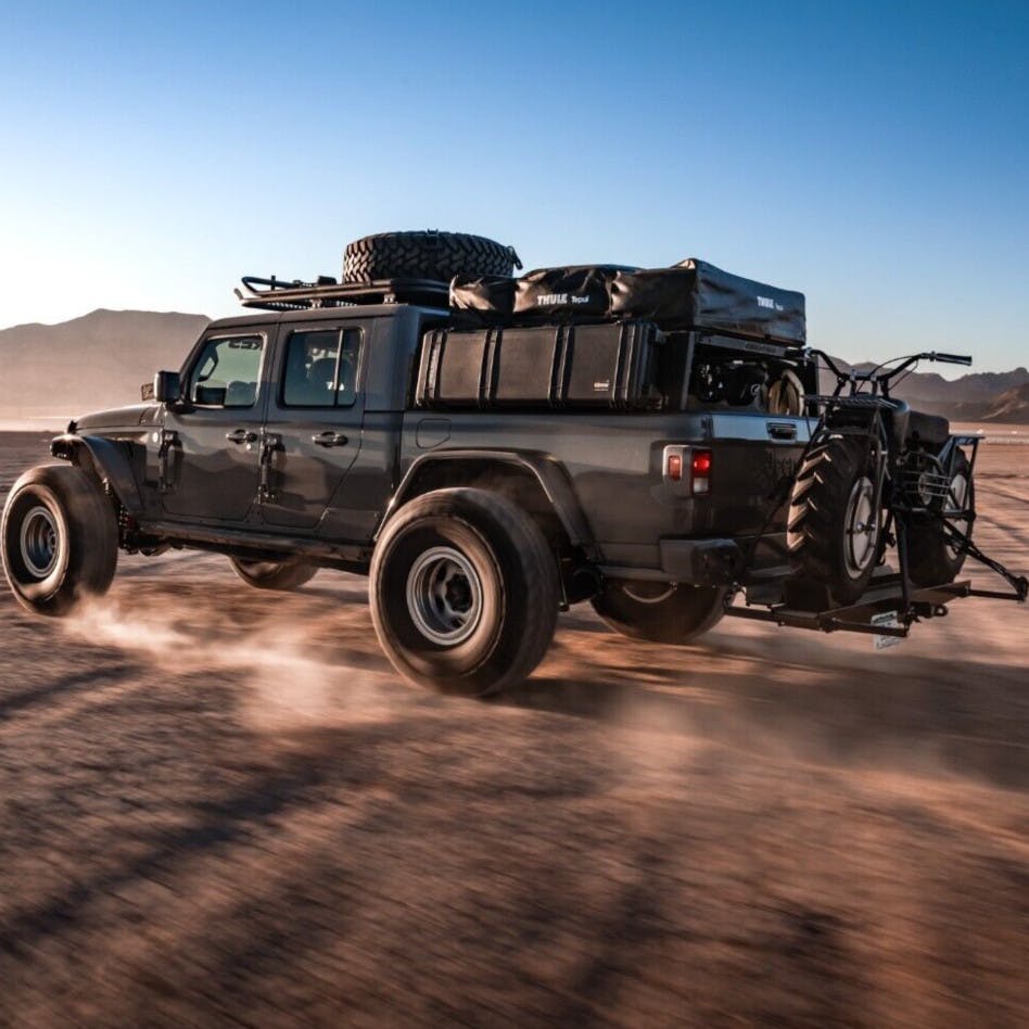 VersaHaul Sport Carrier with Ramp loaded up on Jeep driving through desert