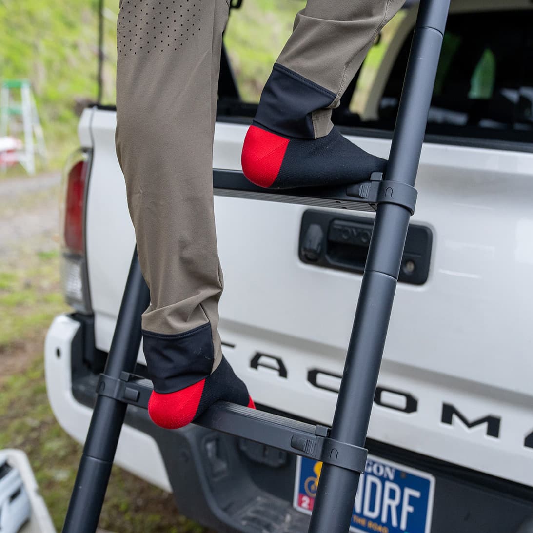 close up of person climbing skypeak hd telescoping ladder