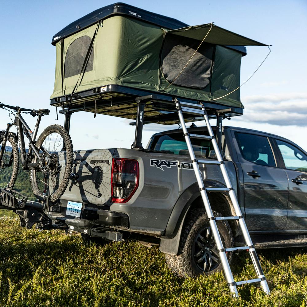 Thule Basin Rooftop Tent Open on Truck in Field Camping