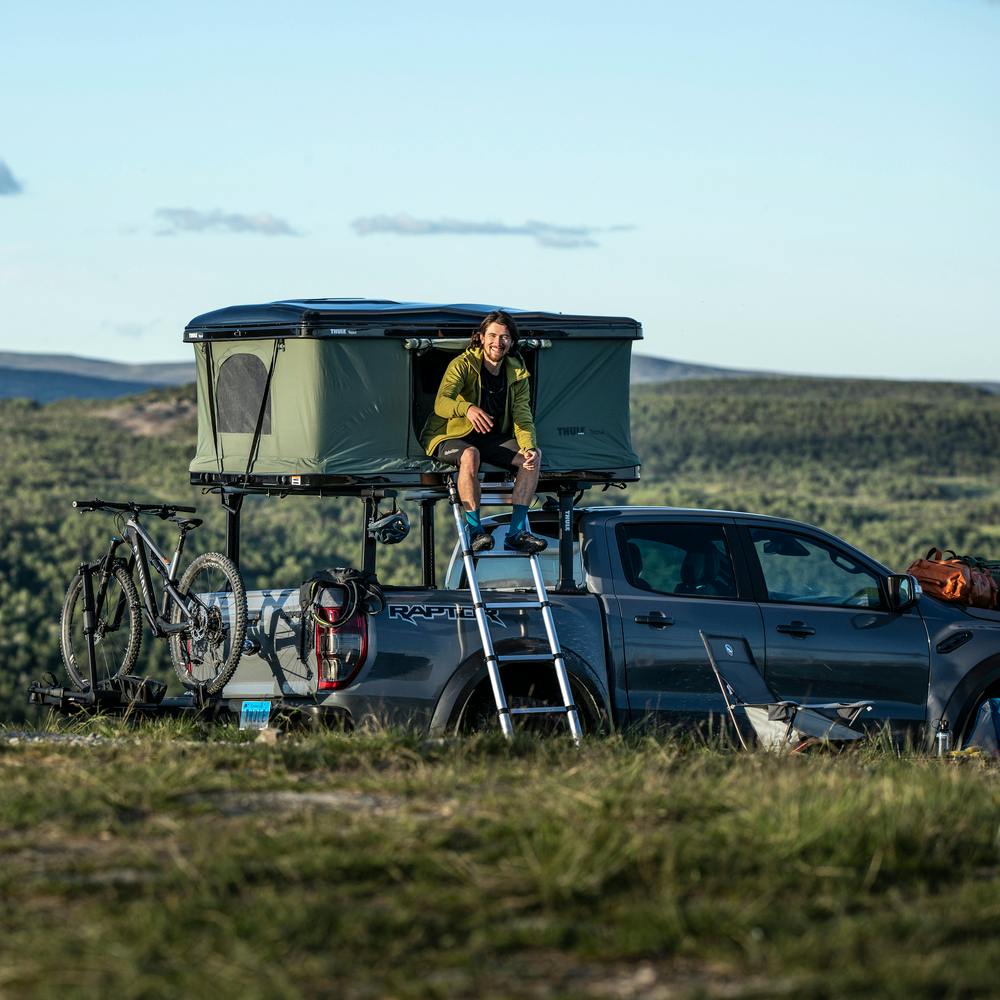Thule Basin Rooftop Tent Open in Field Camping in Distance