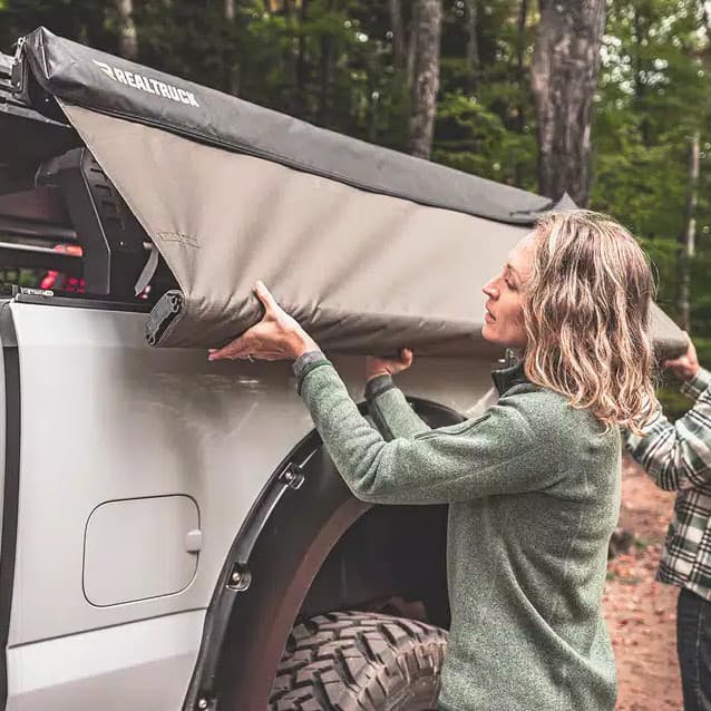 Overland Awning being opened by woman