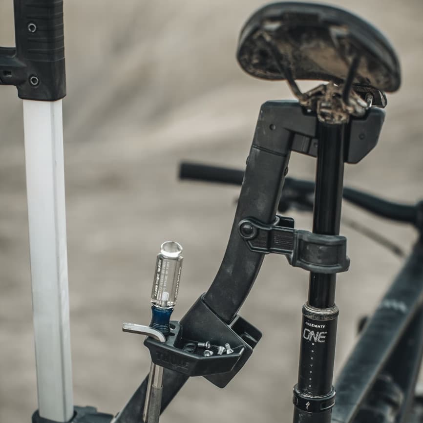 Close up of Thule Bike Repair holder holding a bike out in a natural setting