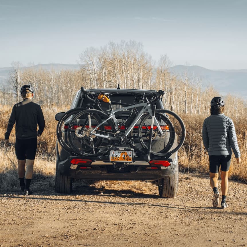 Thule Verse installed with the license plate and lighting kit on back of SUV in nature with bikes loaded on it