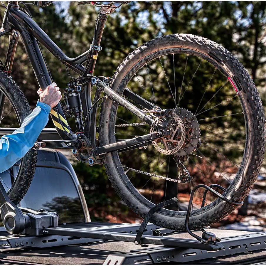 Lifestyle picture of person loded bike onto the Elevate Bike Rack