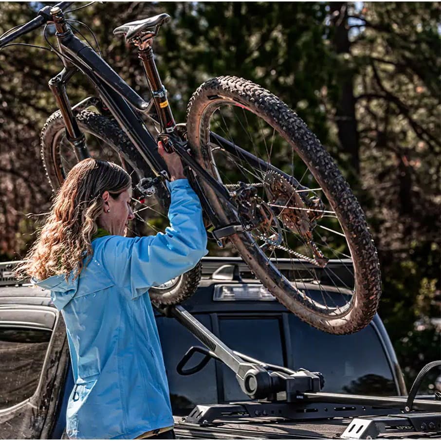 Lifestyle picture of person loading a bike onto the Elevate Bike Rack
