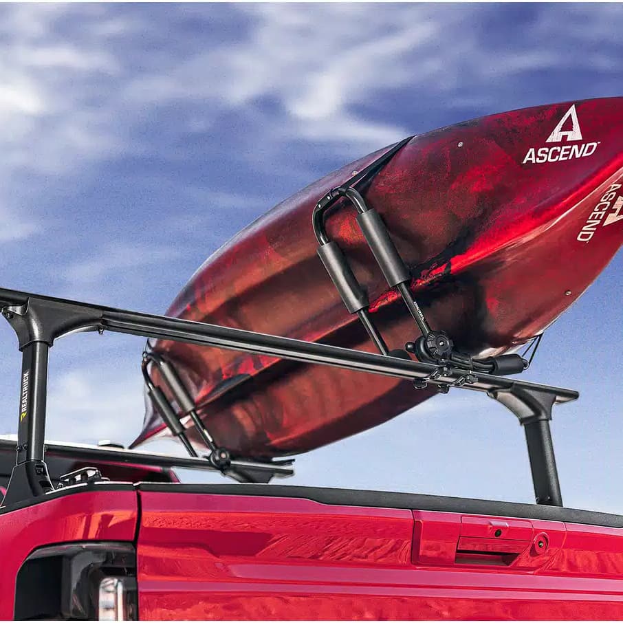 Lifestyle Photo of the Elevate Kayak Rack loaded with a red kayak on Elevate Truck Ladder Rack installed on a red pickup truck