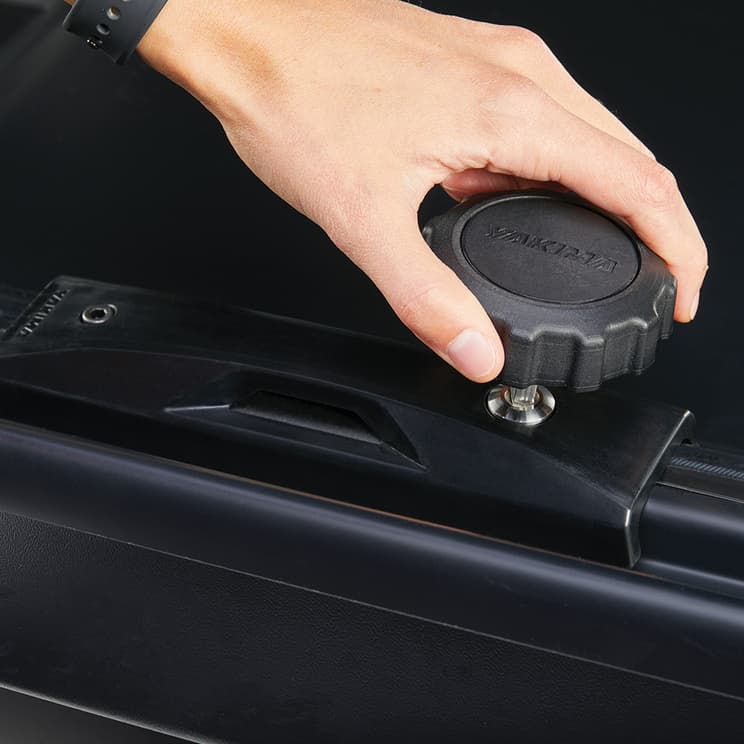 close-up of locking knob used to tighten clamping system around crossbars for installation