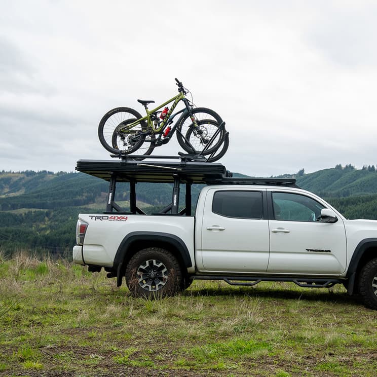 SkyPeak towers and bars loaded with bikes on attached bikerack. Lifestyle pic in nature