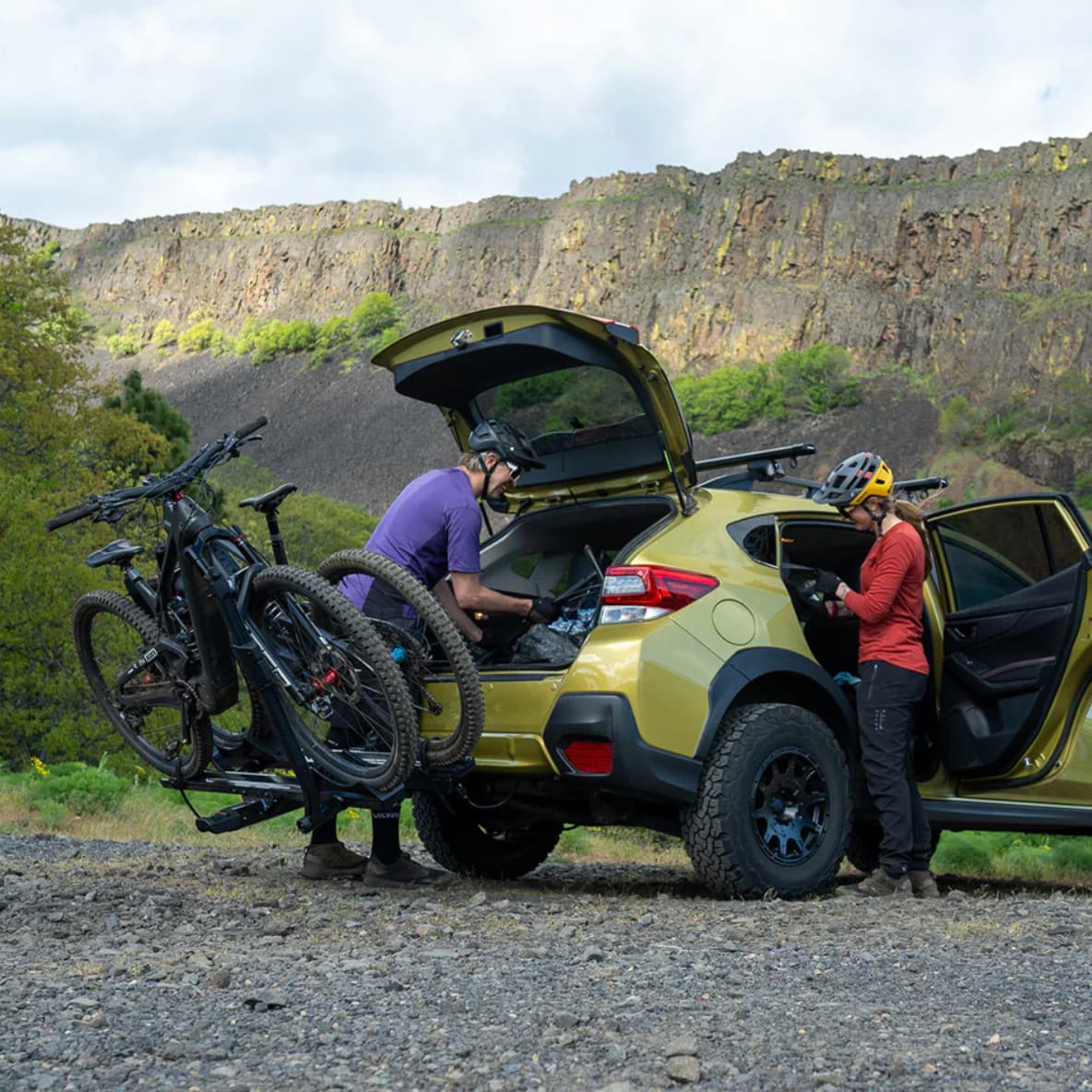 Lifestyle photo of a couple on bikes in nature with the StageTwo on the back of their vehicle